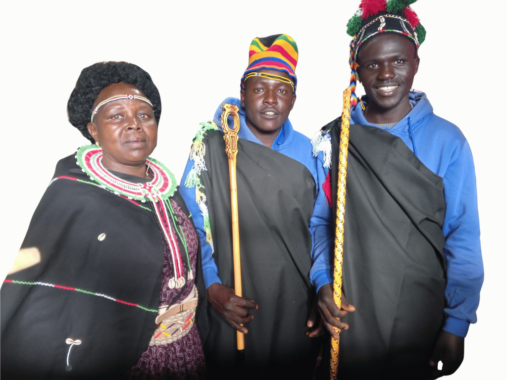 Local Kenyan artisan wearing beaded jewelry and traditional clothing alongside two Pokot men in ceremonial attire