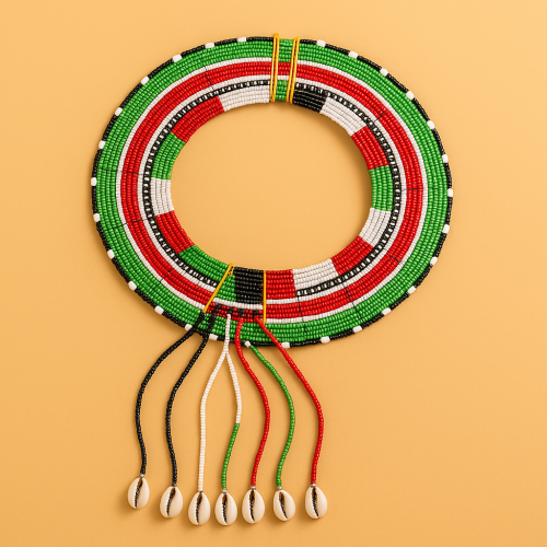 Traditional Pokot beaded necklace in red, green, black, and white with cowrie shells, displayed on a warm beige background.